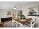 Charming dining space featuring modern light fixture, complemented by a quaint opening to kitchen at 1526 San Mateo Dr, Dunedin, FL 34698