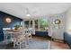 Bright dining room with modern decor, large windows, and stylish furnishings create an inviting atmosphere at 1526 San Mateo Dr, Dunedin, FL 34698