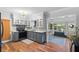 Well-lit kitchen features gray cabinets, backsplash, and stylish lighting fixtures at 1526 San Mateo Dr, Dunedin, FL 34698