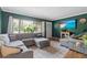 Cozy living room featuring a comfortable sectional sofa, wood floors, and a bright window at 1526 San Mateo Dr, Dunedin, FL 34698