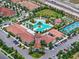 Aerial view of clubhouse, pool, tennis courts, and parking area, highlighting a community's recreational amenities at 17222 Holly Well Ave, Wimauma, FL 33598
