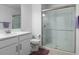 Modern bathroom with a glass-enclosed shower and white subway tile at 17222 Holly Well Ave, Wimauma, FL 33598