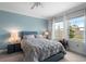 Cozy bedroom with two large windows and a comfortable bed at 17222 Holly Well Ave, Wimauma, FL 33598