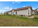 Well-maintained home with a clay tile roof, verdant lawn, and attractive landscaping at 17222 Holly Well Ave, Wimauma, FL 33598