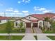 Aerial view of a modern home with a red tiled roof and double garage at 17222 Holly Well Ave, Wimauma, FL 33598