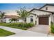 A well-kept home features a neat yard, lovely landscaping, and a two-car garage, all contributing to its curb appeal at 17222 Holly Well Ave, Wimauma, FL 33598