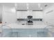 Modern kitchen featuring white cabinets, quartz countertops, and sleek, stainless steel appliances at 17222 Holly Well Ave, Wimauma, FL 33598