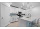 Modern kitchen with white cabinets, stainless steel appliances, and a functional center island at 17222 Holly Well Ave, Wimauma, FL 33598