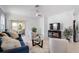 Bright living room with tile floors, modern furniture, and sliding glass doors to the patio at 17222 Holly Well Ave, Wimauma, FL 33598