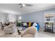 Open-concept living room with large windows and a view into the dining area at 17222 Holly Well Ave, Wimauma, FL 33598