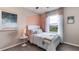 Cozy bedroom with soft pastel accents, a plush bed, and view of community at 17527 Spanish Oak Loop, Land O Lakes, FL 34638