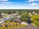 An aerial view showcases a charming home with a screen enclosed pool and beautifully landscaped yard in a quiet neighborhood setting at 1851 Skyland Dr, Clearwater, FL 33759