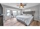 Comfortable bedroom features a large bay window, a ceiling fan, and wood-look flooring at 1851 Skyland Dr, Clearwater, FL 33759