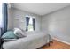 A light filled bedroom with hardwood floors, neutral walls, and a window with curtains at 1851 Skyland Dr, Clearwater, FL 33759
