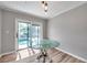 Dining area with hardwood floors, a modern glass table, and sliding glass doors to a patio and pool at 1851 Skyland Dr, Clearwater, FL 33759
