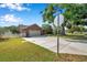 Inviting home featuring a two-car garage, meticulously maintained landscaping, with a long driveway and a cozy curb appeal at 1851 Skyland Dr, Clearwater, FL 33759