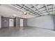 Spacious garage area with two doors and overhead storage, perfect for parking and additional storage at 1851 Skyland Dr, Clearwater, FL 33759