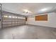 Garage with large overhead door and ample space for parking and storage with overhead lighting at 1851 Skyland Dr, Clearwater, FL 33759