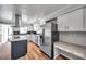 Modern kitchen featuring stainless steel appliances, an island, and white cabinetry at 1851 Skyland Dr, Clearwater, FL 33759