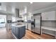 Modern kitchen with stainless steel appliances, center island, and white cabinets at 1851 Skyland Dr, Clearwater, FL 33759