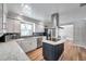 Open kitchen with stainless steel appliances, island cooktop, ample counter space, and sleek cabinetry at 1851 Skyland Dr, Clearwater, FL 33759