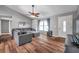 Inviting living room with hardwood floors, ceiling fan, and comfortable gray sectional sofa at 1851 Skyland Dr, Clearwater, FL 33759