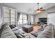 Comfortable living room with hardwood floors, ceiling fan, and a plush gray sectional sofa at 1851 Skyland Dr, Clearwater, FL 33759