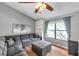 Comfortable living room featuring hardwood floors, ceiling fan, and a cozy gray sectional sofa at 1851 Skyland Dr, Clearwater, FL 33759