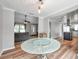 Open-concept living room with wood floors, ceiling fan and abundant natural light at 1851 Skyland Dr, Clearwater, FL 33759