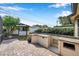 Outdoor kitchen with built-in grill and brick patio, great for entertaining guests at 1851 Skyland Dr, Clearwater, FL 33759