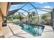 Enjoy the refreshing pool with screened enclosure and lush landscaping at 1851 Skyland Dr, Clearwater, FL 33759