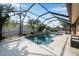 Captivating pool and waterfall feature surrounded by tropical landscaping inside screened enclosure at 1851 Skyland Dr, Clearwater, FL 33759
