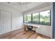 Inviting sun room with natural light, wood floors, large windows, and ample space for work or relaxation at 1851 Skyland Dr, Clearwater, FL 33759
