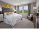 Serene bedroom with a plush bed, contemporary decor, and natural light, creating a cozy and inviting space at 1877 Brekey Way, Zephyrhills, FL 33541