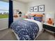 Themed bedroom with playful dinosaur decor, vibrant bedding, and ample natural light for a cheerful space at 1877 Brekey Way, Zephyrhills, FL 33541