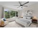 Relaxing main bedroom offers lake views from large window and is furnished with neutral tones at 18939 Duquesne Dr, Tampa, FL 33647