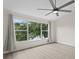 Spacious bedroom featuring modern ceiling fan and bright natural light from the large windows at 18939 Duquesne Dr, Tampa, FL 33647