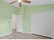 Green bedroom with closet and door leading to bathroom at 18939 Duquesne Dr, Tampa, FL 33647