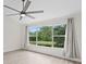 Bright, airy bedroom with large windows offering views of the lush outdoor scenery at 18939 Duquesne Dr, Tampa, FL 33647