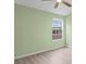 Simple bedroom with bright mint-green walls and large windows offering natural light at 18939 Duquesne Dr, Tampa, FL 33647