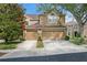 Inviting tan two-story home featuring a two-car garage and well-maintained landscaping at 18939 Duquesne Dr, Tampa, FL 33647