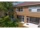 Exterior view of the back of the building with screened in patios and pond view at 18939 Duquesne Dr, Tampa, FL 33647