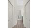 Hallway featuring two spacious closets and bathroom with vanity and toilet at 18939 Duquesne Dr, Tampa, FL 33647