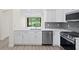 Kitchen featuring stainless steel appliances and quartz countertops with a view out to the screened in patio at 18939 Duquesne Dr, Tampa, FL 33647