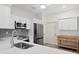 Well-equipped kitchen boasts modern stainless steel appliances, white cabinetry, and an eat-in kitchen bar at 18939 Duquesne Dr, Tampa, FL 33647