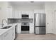 Modern kitchen featuring stainless steel appliances, quartz countertop, and white cabinets at 18939 Duquesne Dr, Tampa, FL 33647