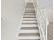 Bright staircase with white risers and light-wood treads offers a clean, modern transition between floors at 18939 Duquesne Dr, Tampa, FL 33647