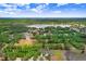 An aerial view showing the home surrounded by mature trees, a large lake, and other properties at 1934 Samantha Ln, Valrico, FL 33594