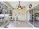 Enclosed back porch features sliding glass doors and comfortable seating at 1934 Samantha Ln, Valrico, FL 33594