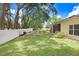 Spacious back yard with an enclosed fire pit and lush green grass at 1934 Samantha Ln, Valrico, FL 33594